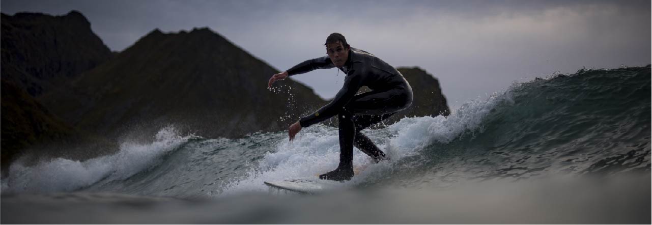 Jakob surfing on a wave